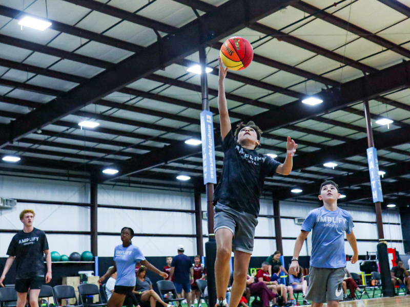 Youth athlete dribbling during basketball training at Amplify Sports