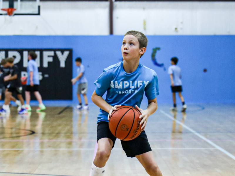 Young basketball players learning game decision making at Amplify Sports